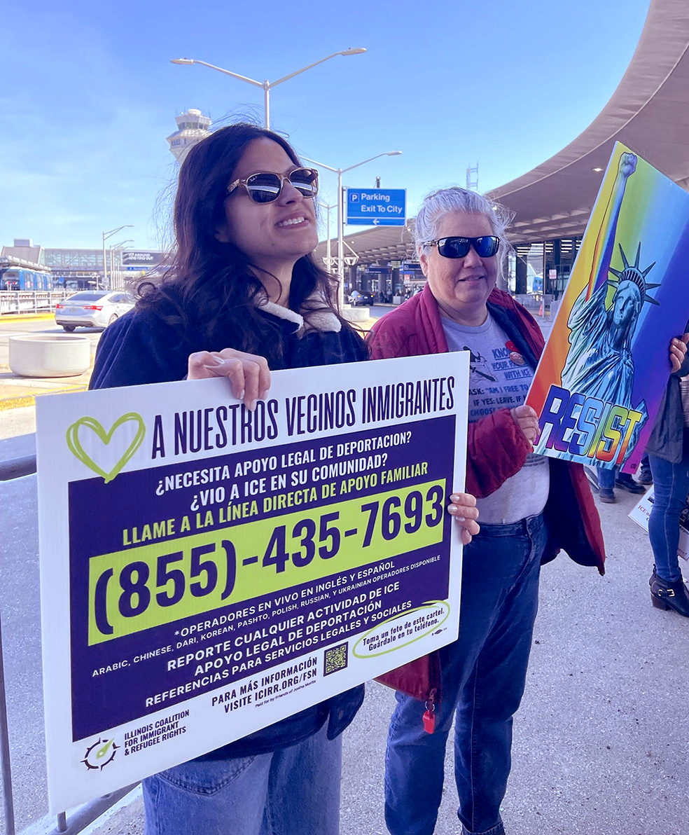 Stephanie Mendoza holding an Illinois Coalition for Immigrant and Refugee Rights hotline sign
